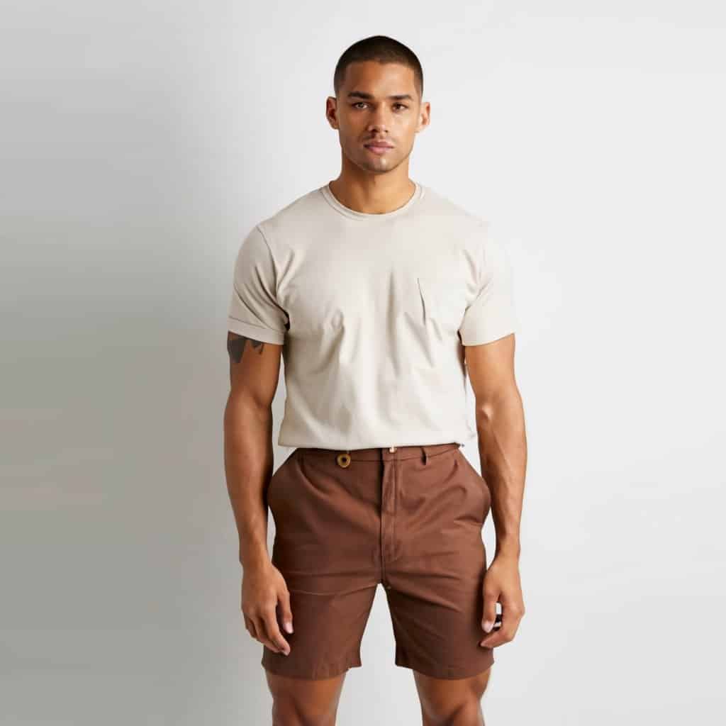 Model wearing brown coloured shorts with white t-shirt